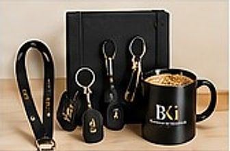 Lanyard, gantungan kunci, notebook, dan mug hitam berlogo BKi
